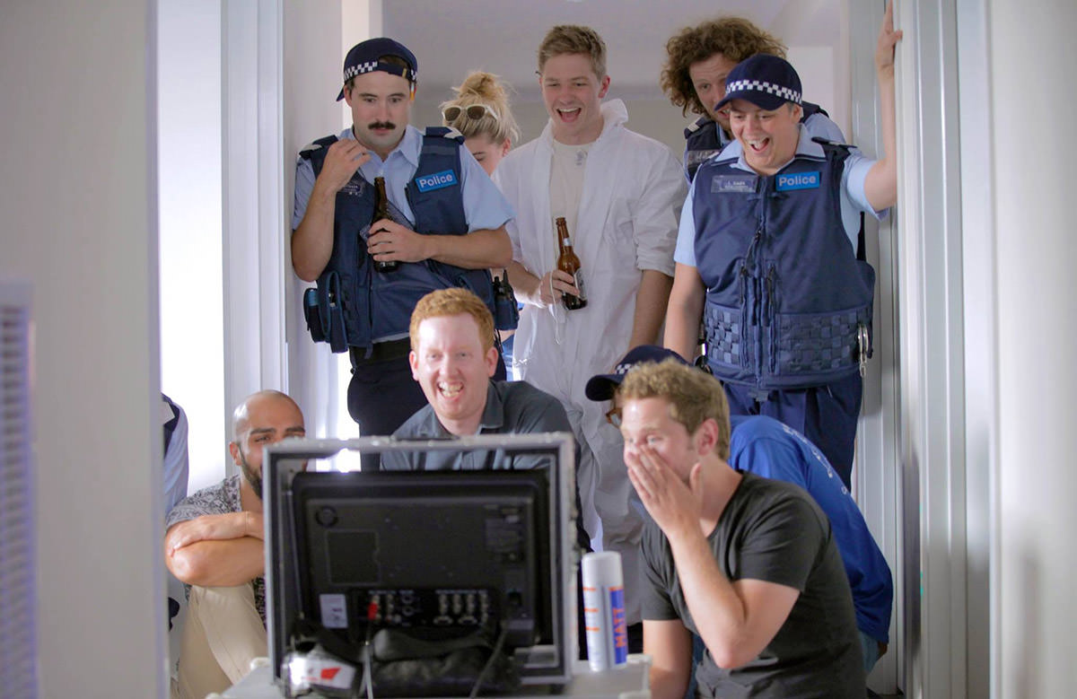 The cast and crew review a shot. From left to right: Mike Nayna, Stuart Daulman, Luke McGregor, Maggie Looke, Jay Morrissey, Nick Capper, Geraldine Hickey, Jonathan Schuster and John Campbell. Supplied by Fancy Boy.