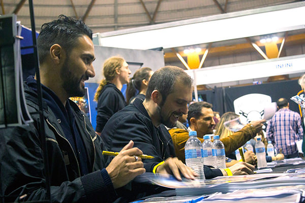 Director Marc Furmie and producer Enzo Tedeschi signing posters at Supanova. Supplied by Deadhouse Films.